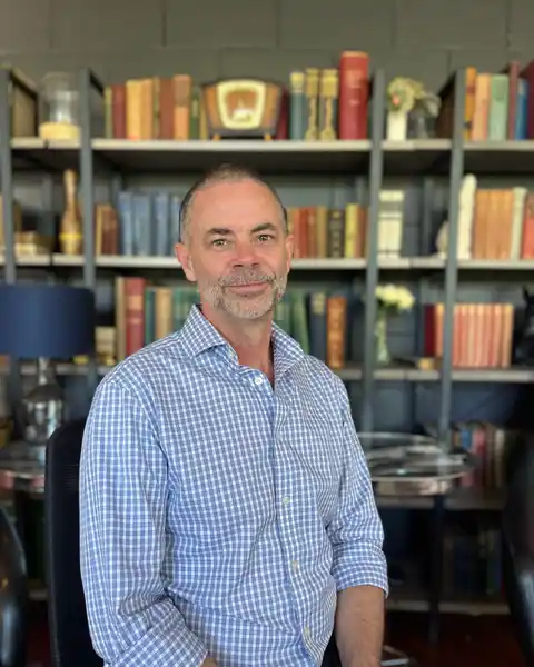 Mark Lucas, seated in the office
